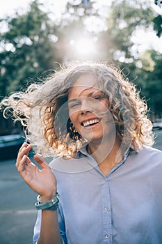 Candid portrait of beautiful young woman laughing in the street