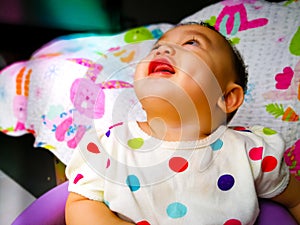 Candid portrait of a cute and expressive Asian baby girl. Lifestyle and childhood concept.