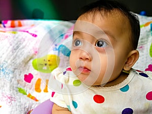 Candid portrait of a cute and expressive Asian baby girl. Lifestyle and childhood concept.