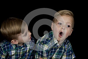 Candid portrait of two young boys wearing matching shirts