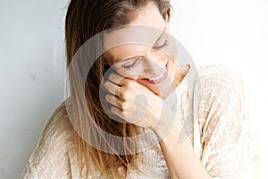 Candid portrait of a woman laughing against white background