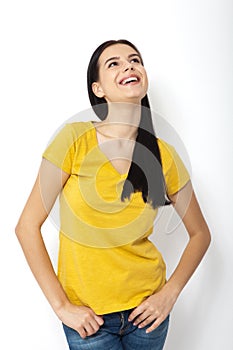 Candid portrait of young woman laughing against white background