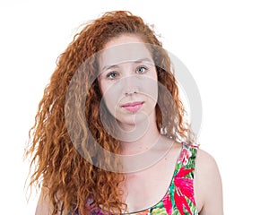 Candid portrait of young woman. Redhead teenager with wavy hair.