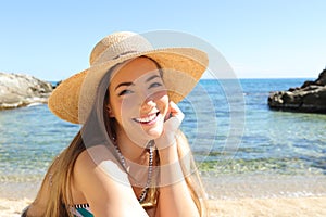 Candid tourist on the beach looking at camera photo