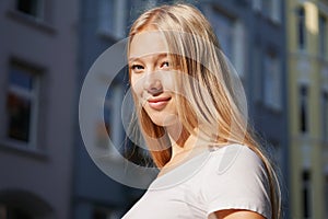 Candid urban street style portrait of blond young woman photo