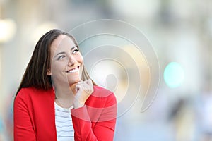 Candid woman thinking looking at side in the street photo