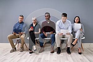 Candidates Sitting On Chair Waiting For An Interview