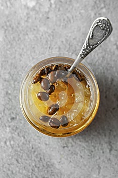 Candied fruit jelly. pear marmalade with coffee beans. Jar of pear jam
