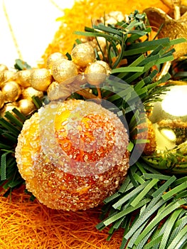 Candied fruits, golden ornaments as Christmas deco