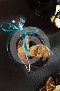 Candied orange slices in a transparent bag. Chocolate sauce. Snack of dried orange slices. Dried orange slices. Sweet