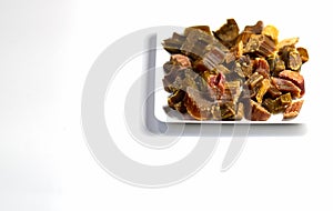 Candied rhubarb on a white background. Dry rhubarb close - up macro photography. Rheum. Dried rhubarb candied fruits