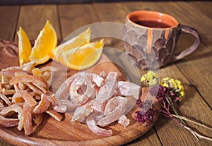 Candied tropic fruits on wooden table