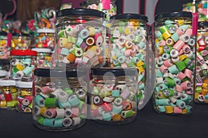 Candies in glass jars in candy shop