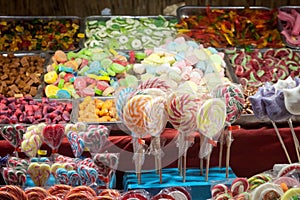 Candies, mainly gummy sweets and lollilpops, diversified, display in loose in a candy shop during a carnival or a fair