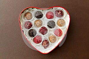 Candies in red heart shaped chocolate box
