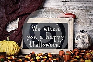 Candies and text We witch you a happy Halloween