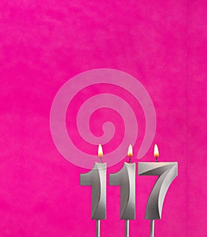 Candle 117 with flame - Birthday card in fuchsia background