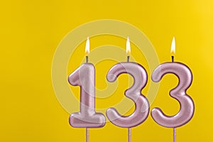 Candle 133 with flame - Birthday card on yellow luxury background