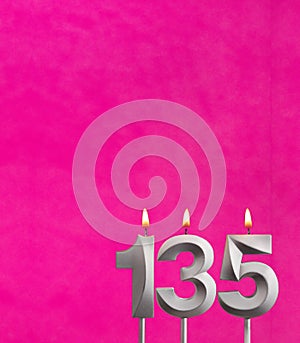 Candle 135 with flame - Birthday card in fuchsia background