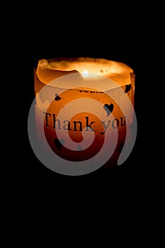 Candle burning with thank you text photo