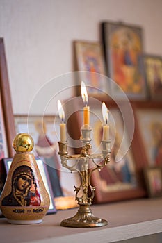Candle against the background of orthodox icons