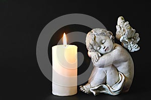 Candle and angel figurine