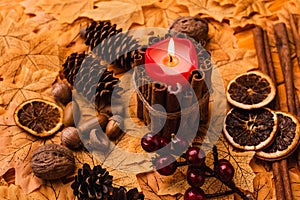 Candle with autumnal brown decoration on