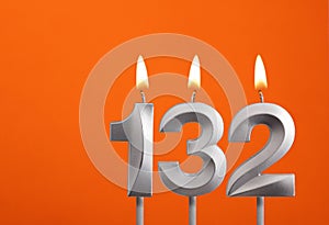 132 candle - Birthday celebration on orange background