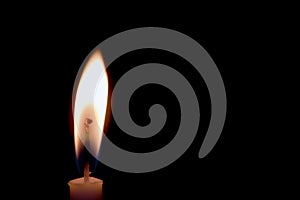 Candle on black background