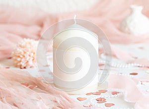 Sealed envelope near pink decorations, hearts and tulle on white table close up, mockup