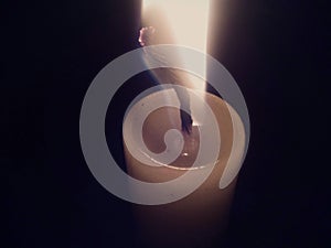 Candle burning in the dark