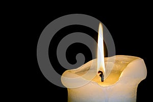 Candle Burning Down over Black Background