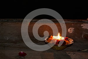 Candle burning in the Ganges, Benares, India photo