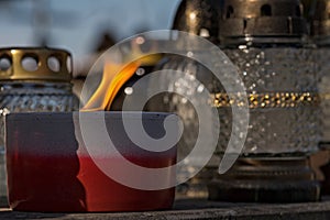 A candle burning on the grave of the victims of the Second World War.