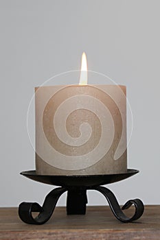 Candle burns with a bright flame in a candlestick, the concept of magic, prayer, spiritualism, mourning