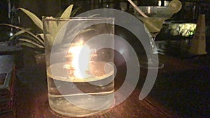 Candle burns on the table of a restaurant in a tropical resort,close up