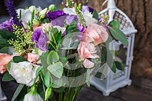 Candle in candelabrum near the bouquet of flowers