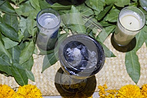 Candle, candles, incense and copal with ornament of sapote leaves in a mud sapwood