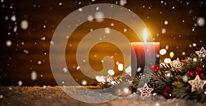 Candle and Christmas decoration with wooden background and snow