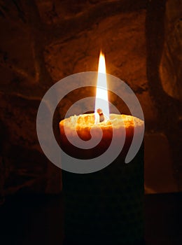 Candle on dark background.