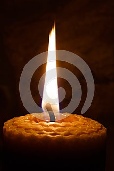 Candle on dark background.