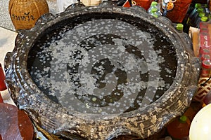 Candle drippings in a basin of water by monk budism in thailand temple photo