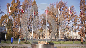 A candle fire burns and Polish flags fly on high masts.