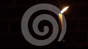 Candle flame close-up on a dark background. Melted Wax Candle light border design. Darkness. 4k resolution video.