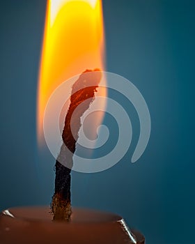 Candle flame. Detail of a candle flame on a dark blue background.