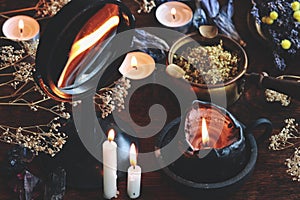 Candle flame divination in concave mirror on wiccan witch altar