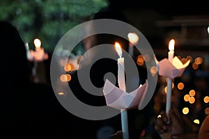 Candle flame light at night with bokeh background. Shallow depth of field photo