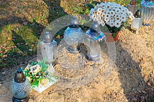 Candle and flowers on grave photo