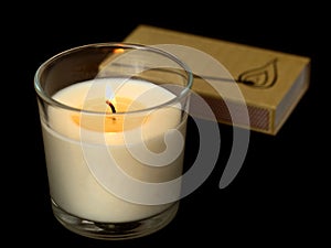 Candle in glass with matches