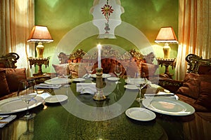 Candle at glass table with serving